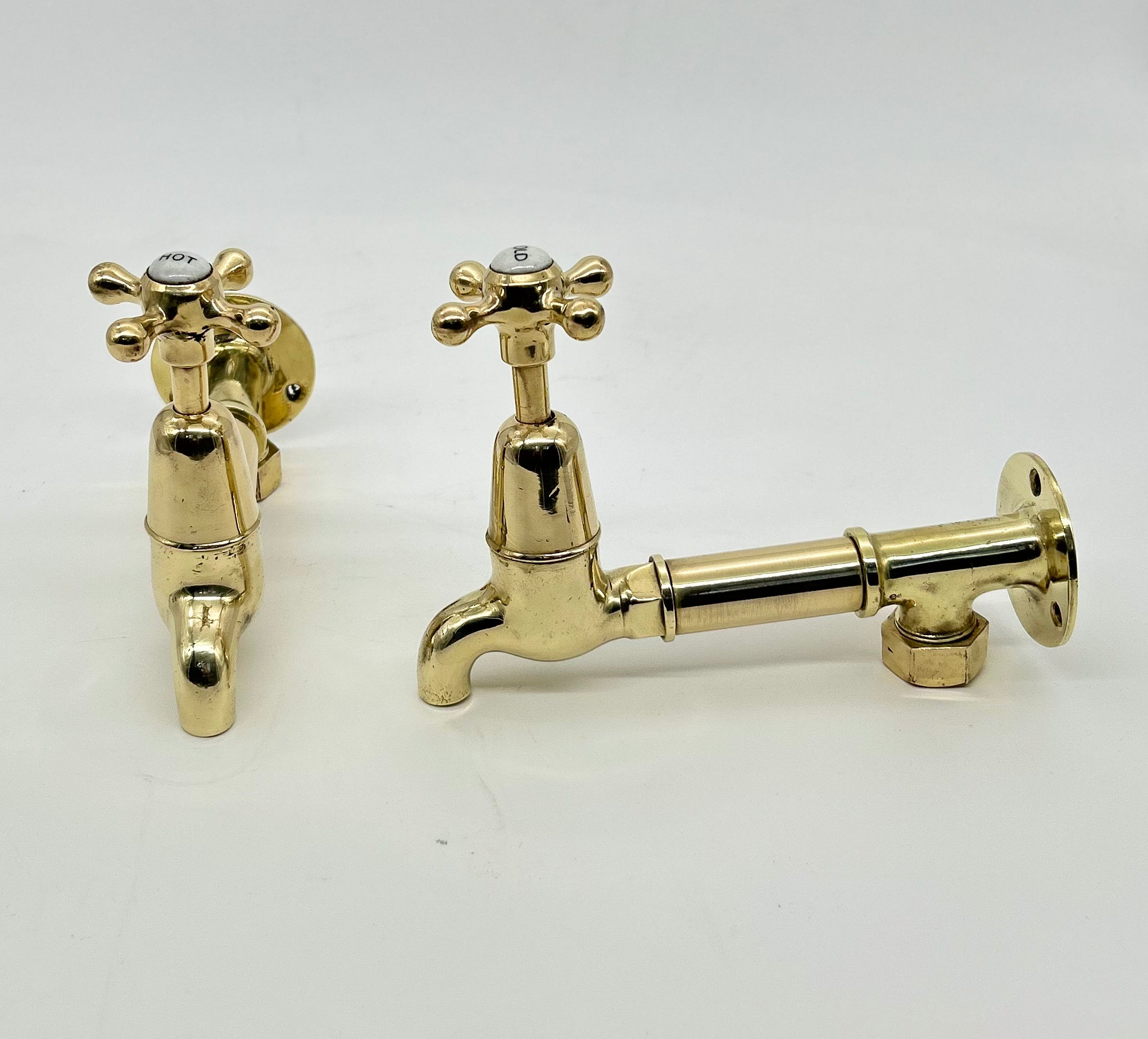 Edwardian Bib Taps on Original Wall Mounts in Unsealed Polished Brass Finish C.1920.