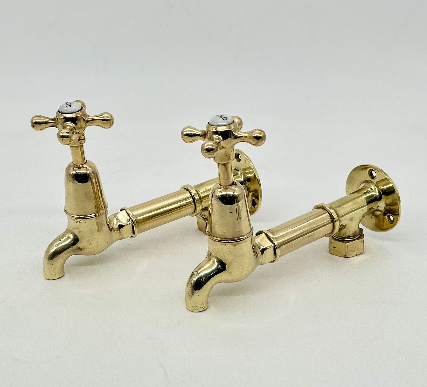 Edwardian Bib Taps on Original Wall Mounts in Unsealed Polished Brass Finish C.1920.