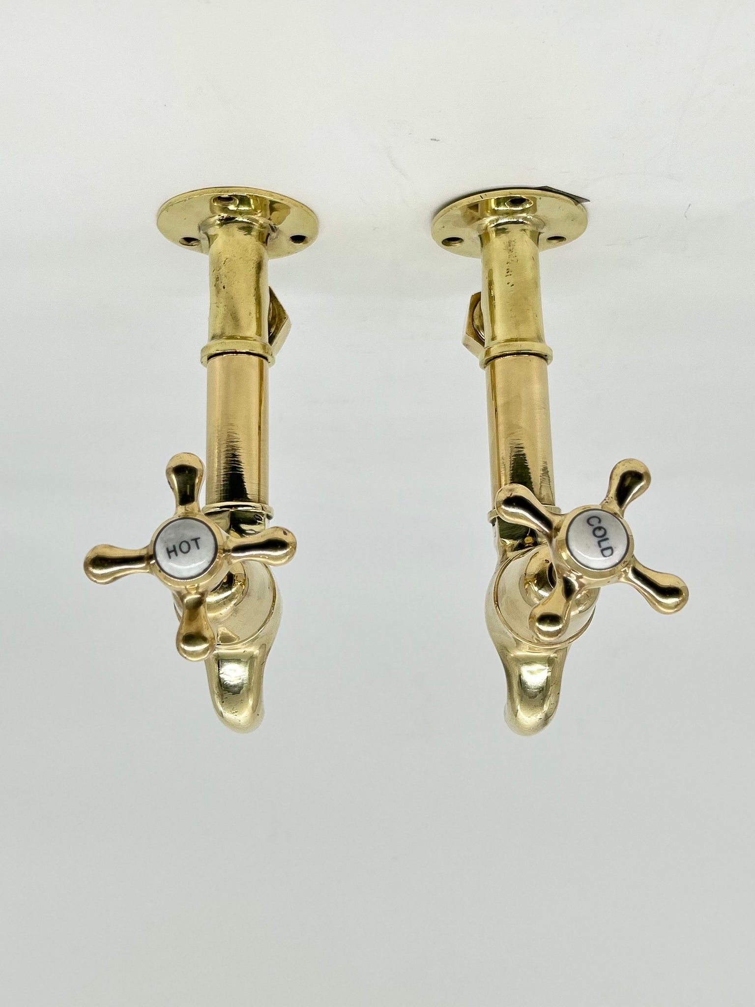 Edwardian Bib Taps on Original Wall Mounts in Unsealed Polished Brass Finish C.1920.