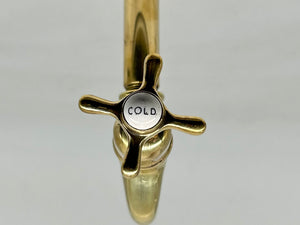 A Pair of Wall-Mounted Kitchen Sink Bib Taps C.1920 in Unsealed Polished Brass Finish.